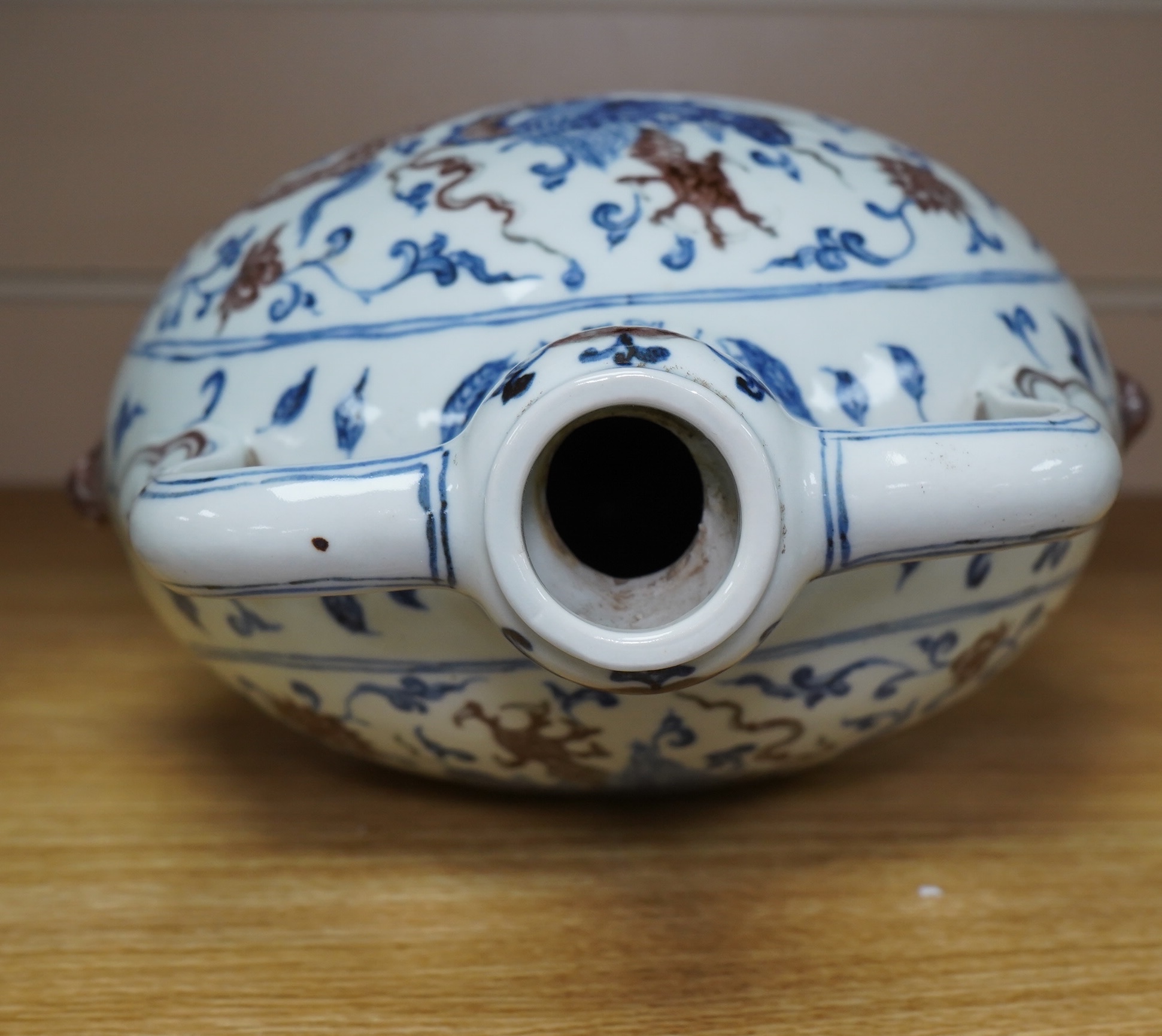 A Chinese blue and white with iron red two handled moon flask, 29cm high. Condition - good